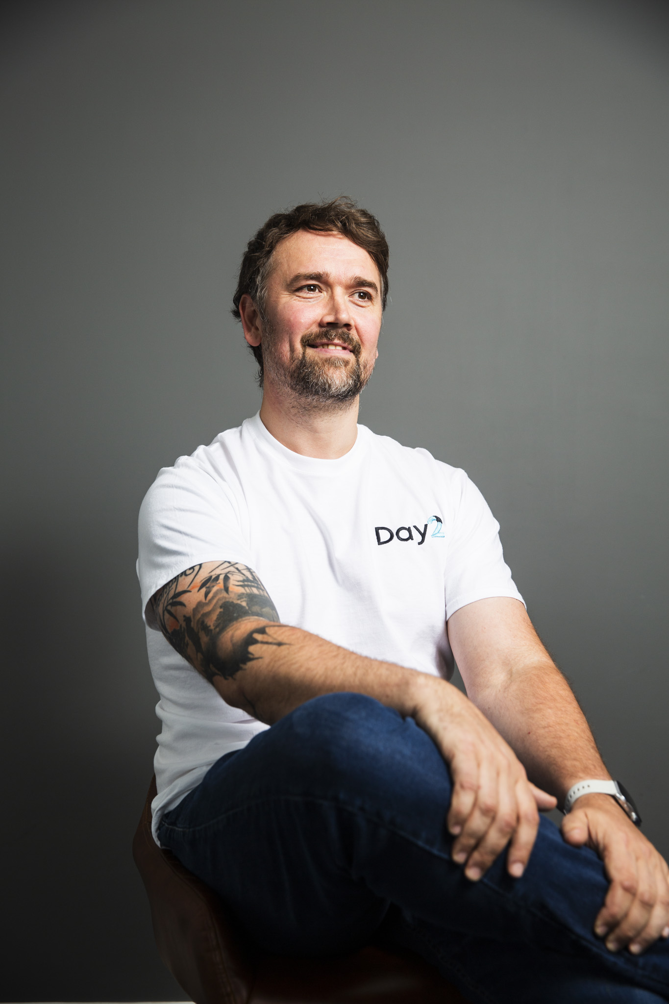 Ed Shaw, seated, wearing a Day2 t-shirt